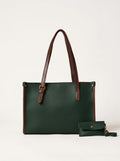 A dark green leather tote bag with brown leather handles and trim, shown next to a matching small green wristlet pouch on a light gray background.