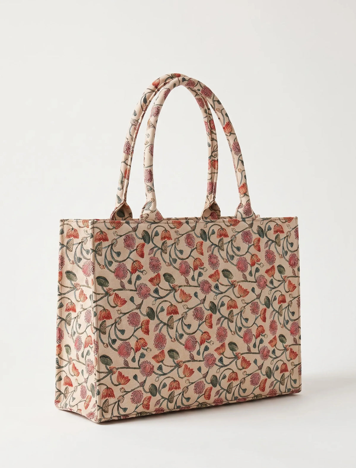 Close-up of ditsy pink and coral floral print on canvas tote bag