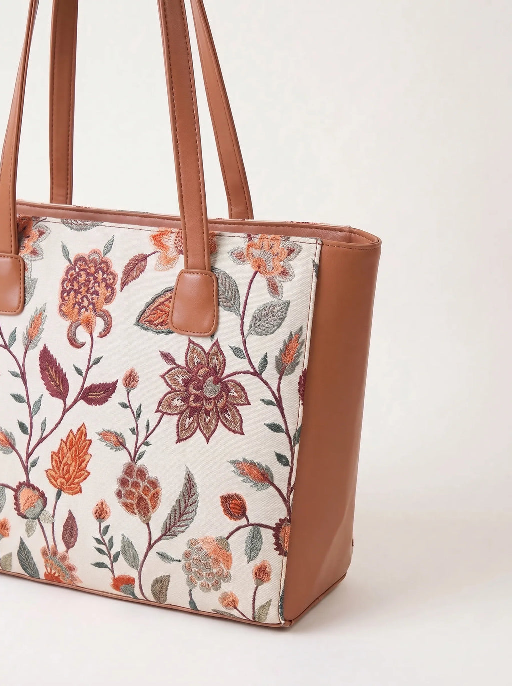 Tan pu leather handles and trim on embroidered canvas tote bag